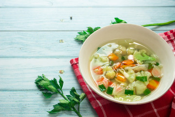 Homemade vegetable soup, overhead, close up view on an old wood background