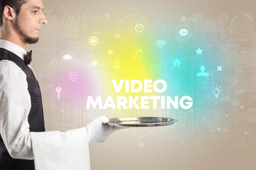 Waiter serving social networking with VIDEO MARKETING inscription, new media concept