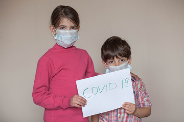 brother and sister in a medical mask during the coronavirus pandemic