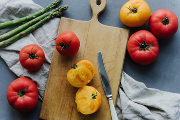 Sliced yellow tomato on a cutting wooden board. Tomatoes on a cutting board.