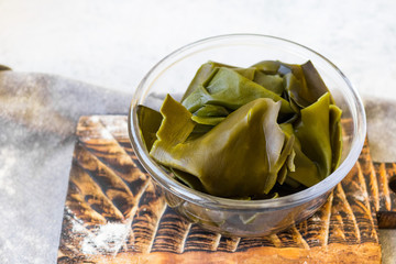 Kombu or laminaria leaves -  Japanese or Chinese seaweed salad. - obrazy, fototapety, plakaty