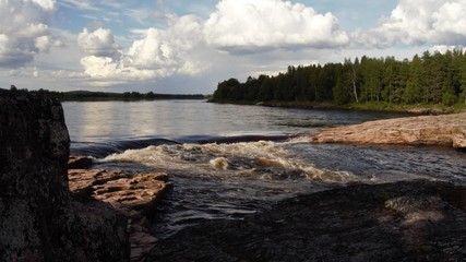 Swedish lapland - nature reserve in summer day in Landscape with Big river, rapids and waterfall in Juoksengy