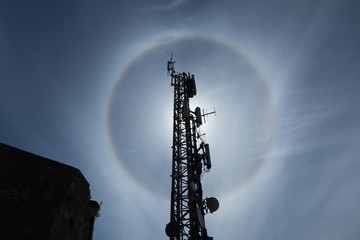 spectacular solar reflection behind a pylon with antennas