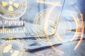 Computer on desktop in office with technology theme hologram. Multi exposure. Tech concept.