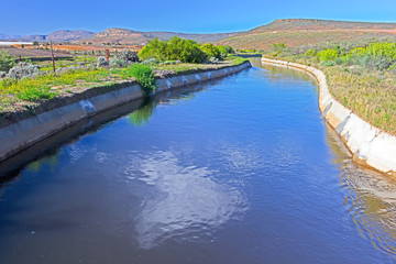 Fototapeta na wymiar Broad concrete lined canal near Oliphants River
