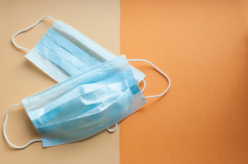 Protective face masks on neutral background. Concept of coronavirus pandemic. Virus and COVID-19 self protection.