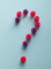 Coronavirus plastic models question mark on a neutral background. Sars-cov-2 pandemic concept COVID-19 pandemic concept 