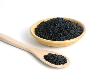 Top view sweet basil seeds on wooden bowl and spoon – isolated on white background