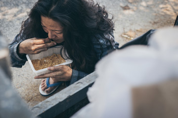 poor people or beggar begging you for help sitting at dirty slum.concept for poverty hunger,human...
