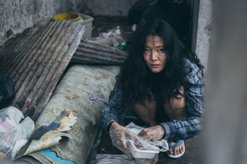 poor people or beggar begging you for help sitting at dirty slum.concept for poverty hunger,human...