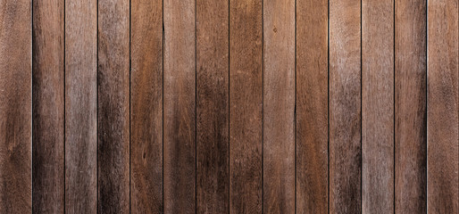Brown wood texture background coming from natural tree. The wooden panel has a beautiful dark pattern that is empty.