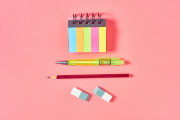 Workplace with stationery accessories on pink countertop. Business or back to school concept. Secretaries workspace