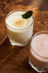 Yogurt with nuts on a wooden background. Side view. Summer food.