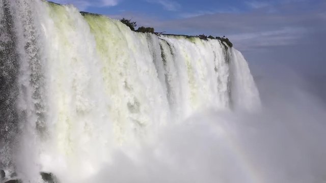 Surreal waterfall flowing backwards. This is the cataratas in Foz do Igua&ccedil;u, Brazil, under blue sky and a lot of water mist in the air