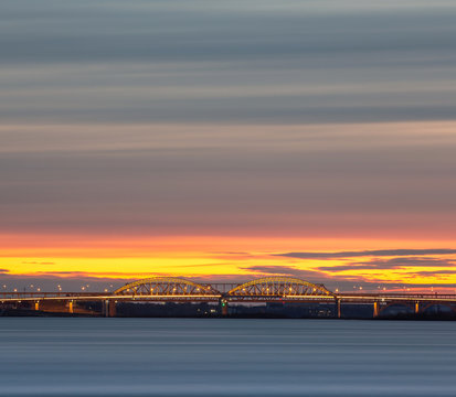 Beautiful bright sunset in the city of Nizhny Novgorod over the Volga River with a view of the Typeset bridge and the Meshchera microdistrict