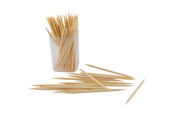 Wooden toothpicks in plastic bottle and scattering on white background. Isolated photo