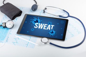 Tablet pc and doctor tools on white surface with SWEAT inscription, pandemic concept
