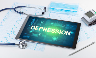 Tablet pc and medical stuff with DEPRESSION inscription, prevention concept