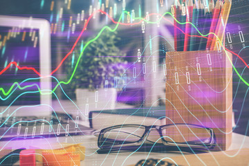 Financial chart hologram with glasses on the table background. Concept of business. Double exposure.