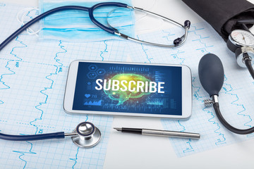 Tablet pc and medical tools with SUBSCRIBE inscription, social distancing concept