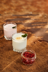 Yogurt with nuts on a wooden background. Side view. Summer food.