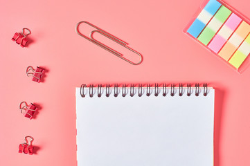 Workplace with stationery accessories on pink countertop. Business or back to school concept. Secretaries workspace