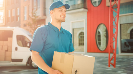 Portrait of Delivery Man Holds Cardboard Box Package Standing in Modern Business District with...