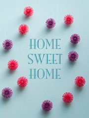 Coronavirus plastic models with inscription Home sweet home. Sars-cov-2 pandemic concept COVID-19 pandemic concept 