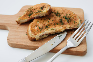 Toast with egg. Birmingham eggs on wooden plate, fork and knife