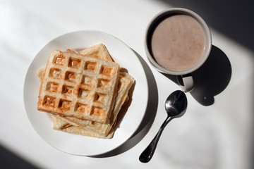 Toasts on white plate with cup of coffee 