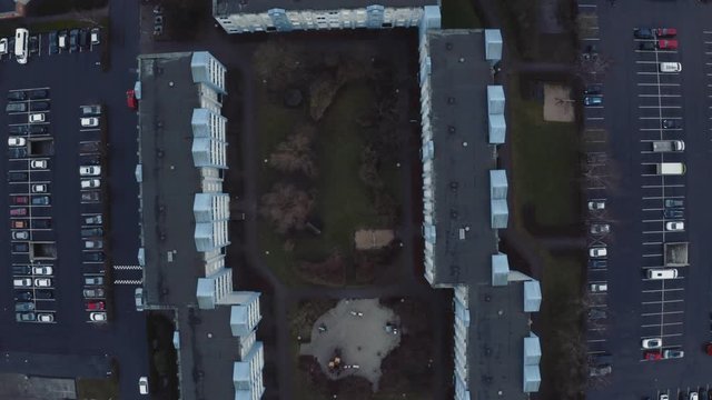Parking lot in danish Ghetto with blue and yellow buildings on cold winter day from aerial drone view. Fj&aelig;ldev&aelig;nget, Aarhus, Denmark.