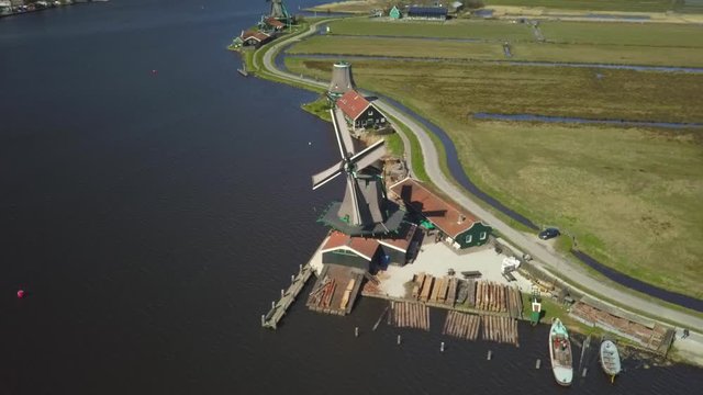 A paralel shot of some Windmills over the water at Zaanse Schans around Amsterdam.