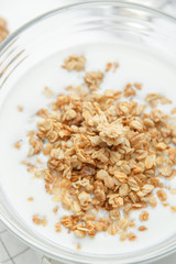 Porridge flakes in a bowl with milk. Granola for Breakfast with yogurt and walnuts.