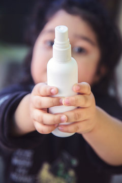 Close Up Of Kid Hand Holding Bottle With Antiseptic Cleaning Gel. Kids Use Alcohol Gel To Wash Hands To Prevent Coronavirus, Covid-19 Pandemic.