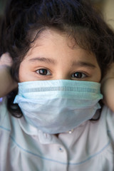 Coronavirus and Air pollution pm2.5 concept.Little Indian girl wearing mask for stop corona virus outbreak.Wuhan coronavirus and epidemic virus symptoms.