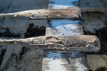 two weathered oars with peeling layer of lacquer