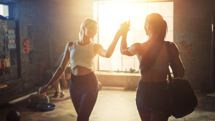 Shot of the Beautiful Athletic Woman Walking into Hardcore Gym, Greets Her Friends and Fellow Athletes. Ready for Her Power Workout, Strength Exercise and Bodybuilding Training Session