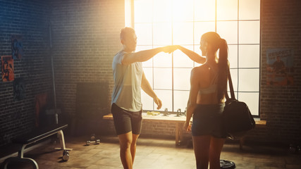 Shot of the Beautiful Athletic Woman Walking into Hardcore Gym, Greets Her Friends and Fellow Athletes. Ready for Her Power Workout, Strength Exercise and Bodybuilding Training Session