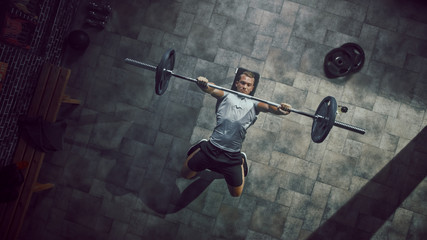 Top View of Professional Athlete Doing Bench Press Workout with a Barbell in the Hardcore Gym....