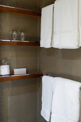 Elegant modern design bathroom with plush towels and shelf in cabin or stateroom on luxury cruise...