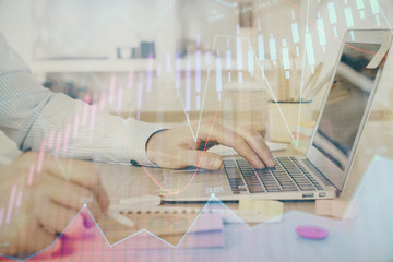 Multi exposure of stock market graph with man working on laptop on background. Concept of financial analysis.