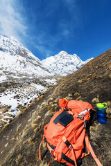 Mountaineer's equipment,backpack, bottle of water, glasses, solar charger on the stone high in the Himalayas mountains
