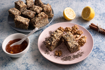 Homemade poppy seeds pie with with ingredients for baking on a rustic table, breakfast or dessert, traditional poppy pie with chopped walnuts and apricot jam
