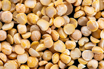 halves of dried crushed pea seeds on a black background