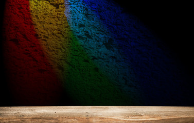 empty countertop on a dark background with bright rays of light.