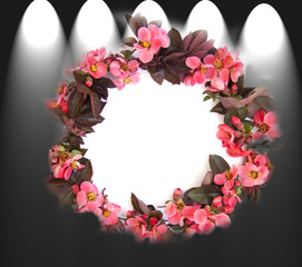 Round frame with pink buds of flowers, branches and leaves isolated on a white background. layout, top view, space.