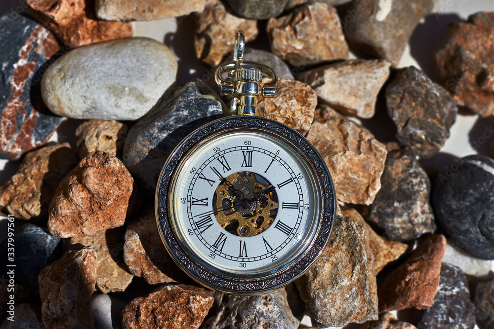 Wall mural vintage pocket watch on the rocks