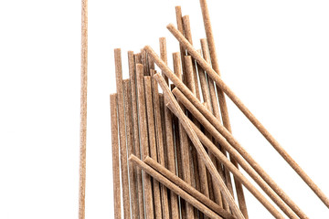 plain and brown spaghetti made from buckwheat flour next to a white or black background