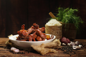 Deep fried pork made form sliced pork with sauce, garlics and pepper, Delicious cuisine served with sticky rice or steamed rice. Selective focus and free space for text. Yummy food good taste concept.