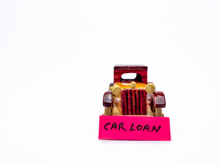 Front shot of a wooden toy car with white background and copy space in loan concept.